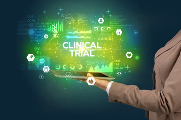 Close-up of a touchscreen with CLINICAL TRIAL inscription, medical concept