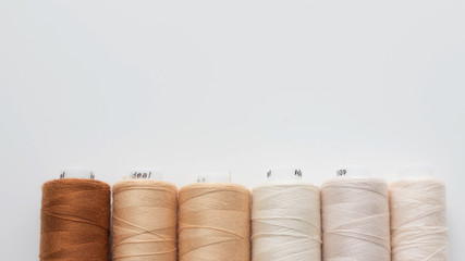 Color sewing threads on white background