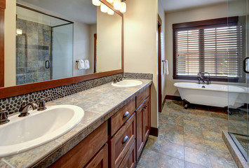 New rustic luxury home bathroom for guest design details with rich wood and grey stone.