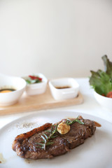 beef steak with salad on white table