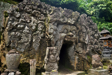 Fototapeta na wymiar Ancient sculpture carving gate entrance tunnel of Goa Gajah or Elephant Cave significant Hindu archaeological site for travelers people travel visit and respect praying at Ubud city in Bali, Indonesia