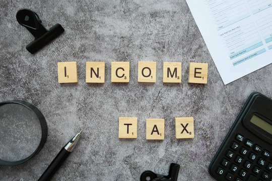 Wood text "Incone Tax" on clear background for Business concept.