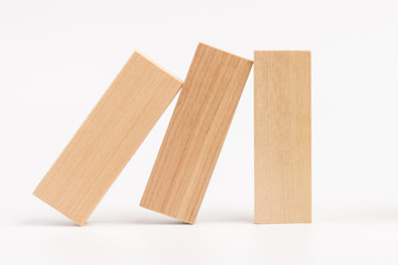 Domino effect, row of wood domino on white background
