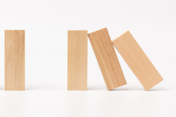 Domino effect, row of wood domino on white background