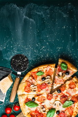 Traditional Italian pizza on a green chalkboard with ingredients. Pizza menu. Space for text. view from above