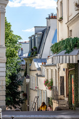 Paris, France - May 20, 2020: Typical stairs and Haussmann buildings in Montmartre in Paris