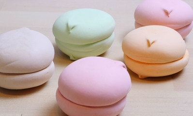 pattern, sweet dessert, colorful marshmallows on the surface of a wooden table. Casts a shadow Sugar addiction, intake, carbohydrates