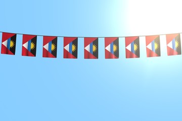 nice many Antigua and Barbuda flags or banners hanging on string on blue sky background - any occasion flag 3d illustration..