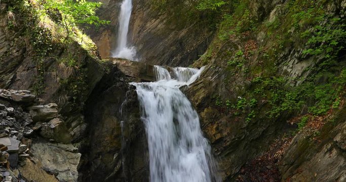 Three-stage waterfall in the spring in the mountains