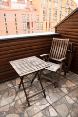 wooden chair and table on modern balcony