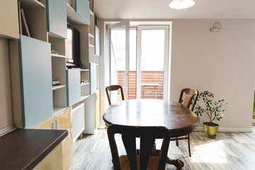 modern dining room with wooden chairs and table near green plant