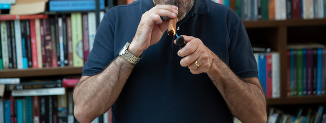 Man lights a cigar lighters from.