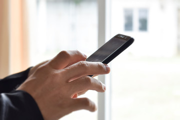 Close up of man hand using smartphone. Idea for business, online banking, technology, send sms.