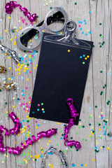 Directly Above Shot Of Clipboard With Colorful Confetti At Table
