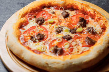 Pizza with bacon, tomatoes, cheese and olives. Italian Cuisine.