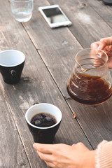 coffee cup on a wooden table/v60 black coffee outdoors