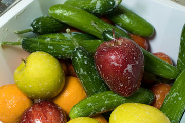 Soapy fresh apples cucumbers and oranges at kitchen