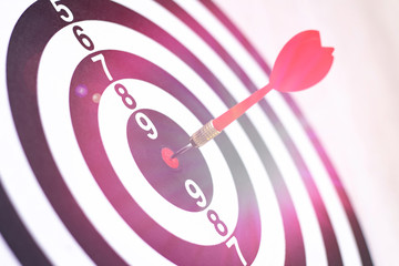 Dartboard with hit bullseye on white background, closeup. Bullseye is a business target. Target...