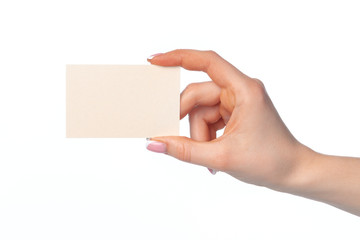 Obraz premium Female hand with blank white business card isolated on white