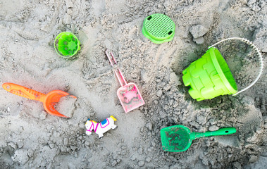 Toys are scattered around the children's sandbox. Plastic toys. Sandbox. Children's games on the...