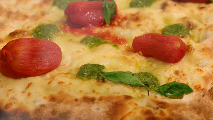Close up of italian pizza with red tomatoes and mozzarella chees