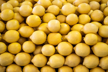 Organic lemons freshly harvested on a market counter