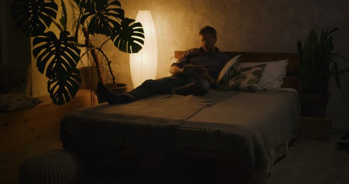Man switching lighting on and off with home hub