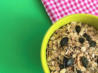 healthy food green deep clay bowl of cereal pink white tablecloth with the green background
