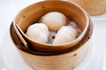 Chinese dumpling in a bamboo steamer box