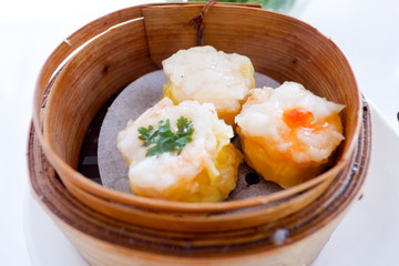 Chinese dumpling in a bamboo steamer box