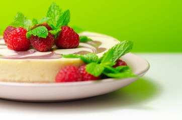 Creamy vanilla baked cheesecake, swirled with raspberry sauce on a biscuit crumb base