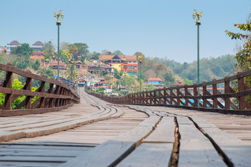 Fototapeta na wymiar Mon bridge, officially name is Auttamanusorn-Wooden-Bridge. A wooden bridge across the Songgaria river to the village of Mon. It is the longest wooden bridge in Thailand. 