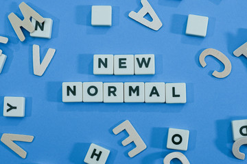 Text on block letters on new normal on blue background