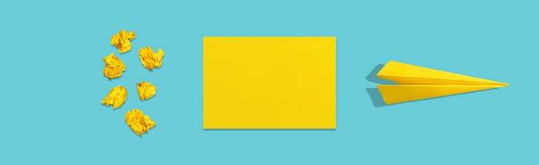 Crumpled paper, blank sheet and crafted plane on blue background. The concept of brainstorm and...