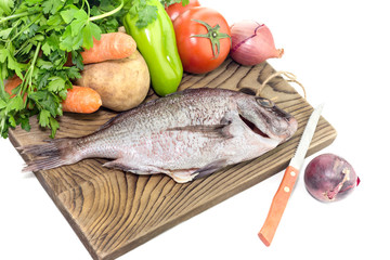 The peeled fish (Pagrus pagrus ) with vegetables on a white background