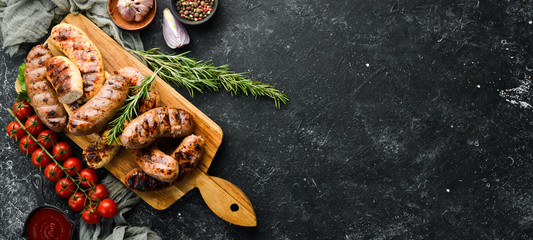 Grilled sausages with spices. Barbecue. Top view, free space for your text. Rustic style.