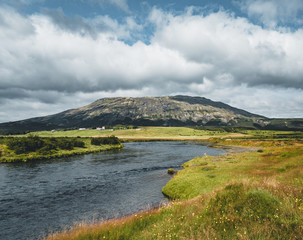 Obraz premium Glacial River Bruara leading towards waterfall bruarfoss in Iceland., Beautiful summer view during midnight sun with blue sky and clouds. Southwest Iceland during Summer.