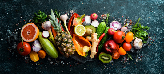 Organic food: Fresh vegetables and fruits on a dark background.