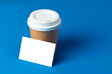 Blank takeaway coffee cup and white businesscards
