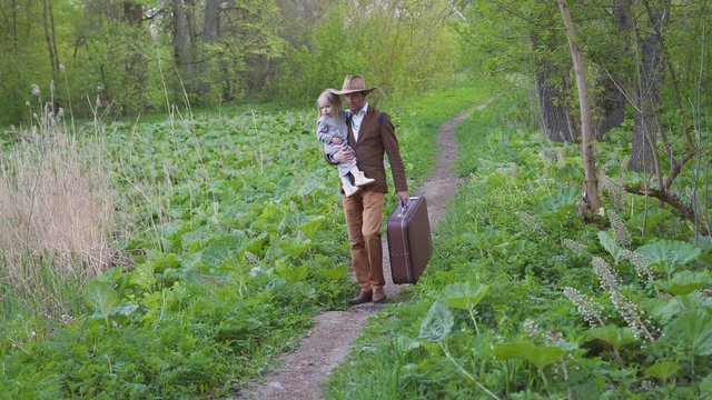 Father with a little daughter goes on a trip.