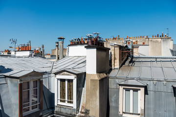 Fototapeta na wymiar Rooftops of the houses in Paris with Chimneys.