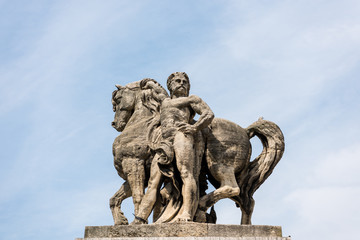  Statue Of Man And Horse on at the bridge pier on the bank of Seine river, in the downtown of Paris, France.