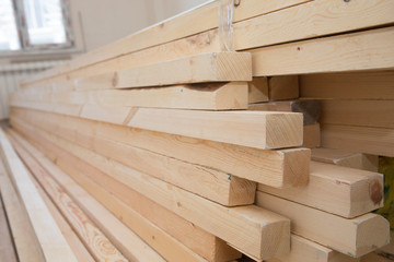 Timber industry objects. Finished wood beams or plank at a warehouse. Hardware store, construction material for background and texture, Wood products, planks, lining, boards for construction works .