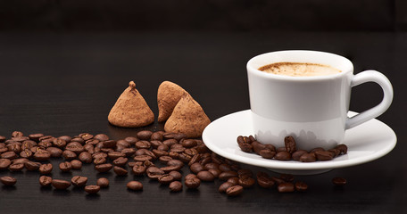 A cup of coffee is on the table.