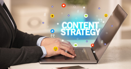 Freelance woman using laptop with CONTENT STRATEGY inscription, Social media concept
