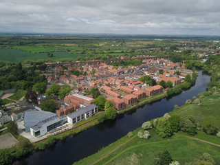 Fototapeta na wymiar The historic market town of Yarm in North Yorkshire from above by drone showing the River Tees 