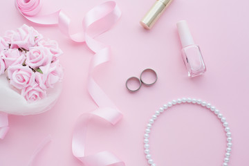 Wedding flat lay with pearl jewelry and a wedding bouquet. Concept photo on a wedding theme.