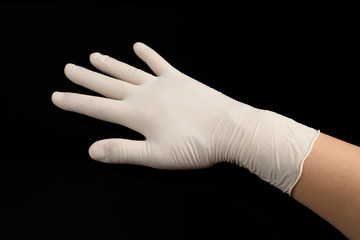 Beige latex gloves, on black background. Protector to prevent contagion.