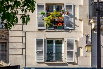 Fototapeta na wymiar Paris, France - May 14, 2020: Window with flowers in a parisian house