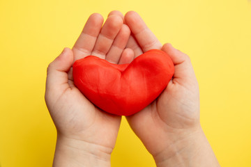 Obraz premium Red plasticine in children's hands